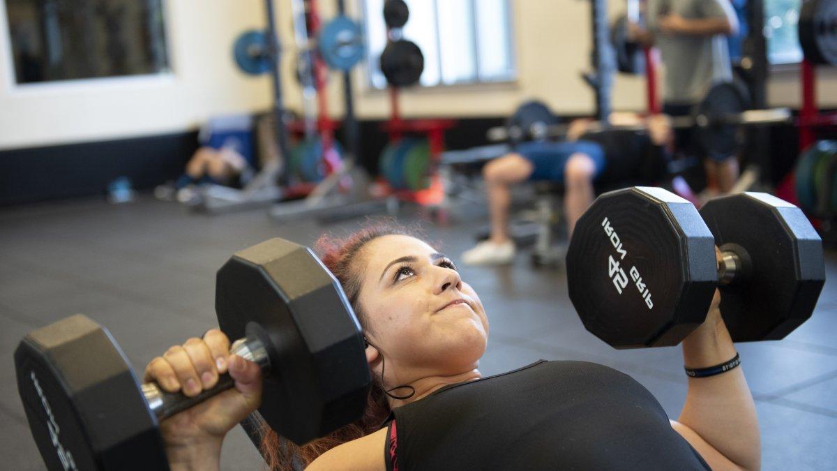 Student lifting weights at the Rec Center